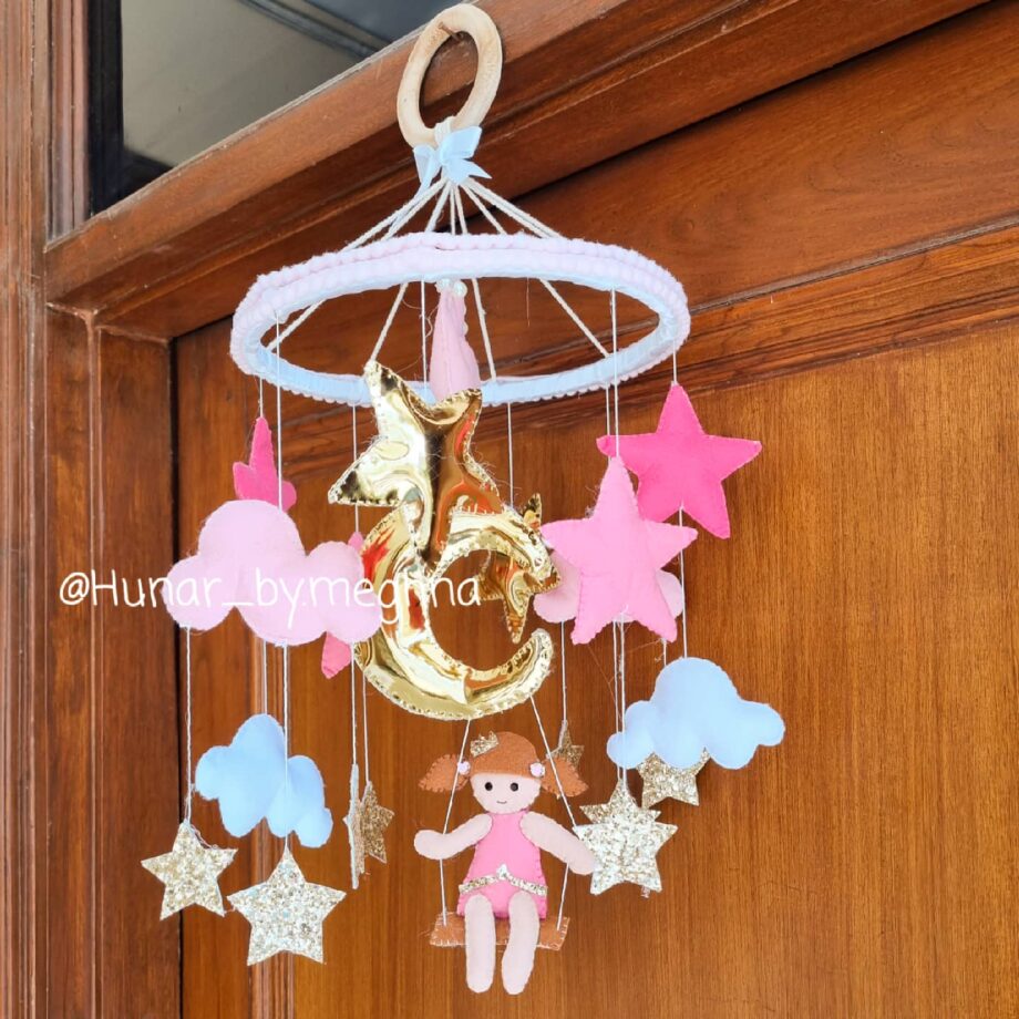 Doll on swing baby mobile