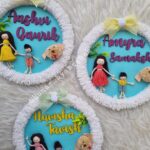 siblings doll name hanging in a furry ring