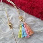 couple rakhi pair in pretty pastel colors