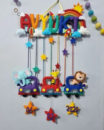 bright colorful kids name hanging with rainbow macrame and felt stitching with cars having animals