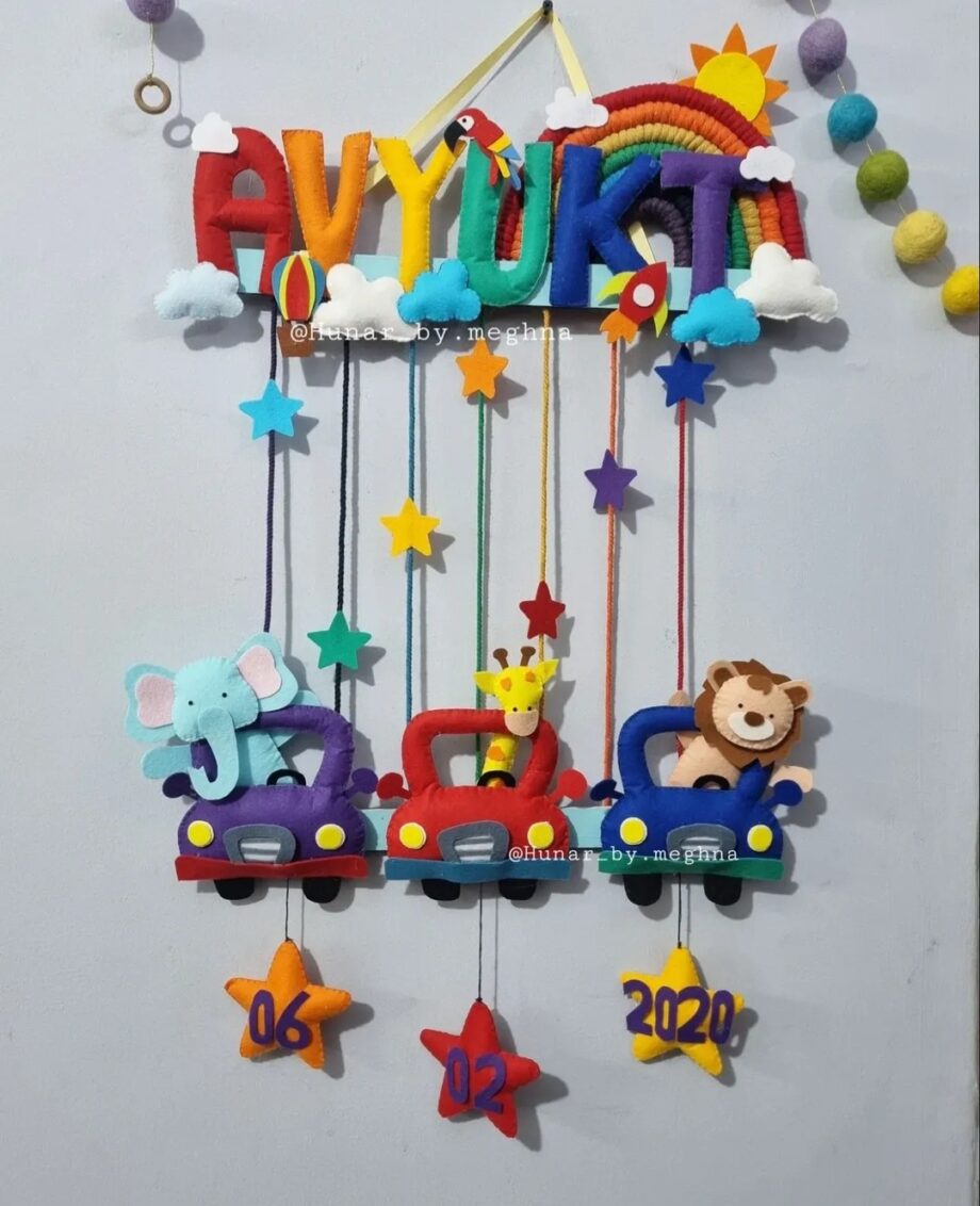 bright colorful kids name hanging with rainbow macrame and felt stitching with cars having animals