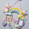 plushy unicorn and pastel rainbow name hanging with birth stats details