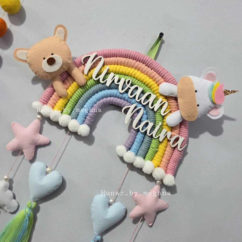 handcrafted macrame rainbow in pastel colors with kids name and cute felt unicorn and felt teddy