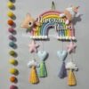 handcrafted macrame rainbow in pastel colors with kids name and cute felt unicorn and felt teddy cotton thread tassles with cute hearts, stars and clouds