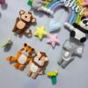 cute felt handmade animals lion, tiger, elephant, koala, bunny, bear, koala and monkey on cute macrame pastel rainbow