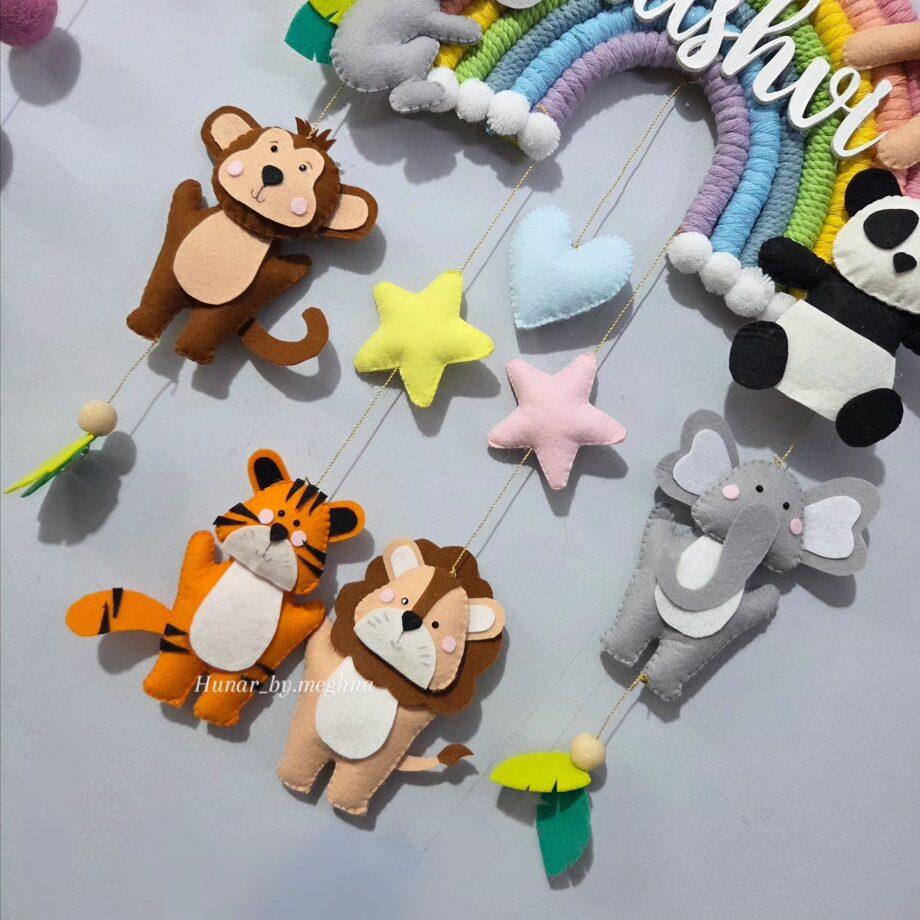 cute felt handmade animals lion, tiger, elephant, koala, bunny, bear, koala and monkey on cute macrame pastel rainbow
